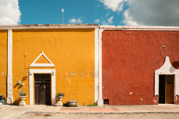 mexico background shabby wall color combinations. Red and orange walls. Blue sky. scorching midday sun. summer moment atmosphere