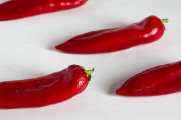 Red paprika peppers on a white table. Background