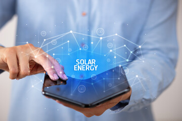 Businessman holding a foldable smartphone, new technology concept