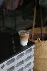 Closeup of Iced Caramel Macchiato at the coffee shop, Caramel Macchiato is a classic macchiato beverage. It consists of vanilla syrup, espresso, steamed milk, foam, and caramel drizzle          