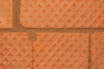 Texture of red brick. Brickwork with gray cement joints. Abstract background. Close up
