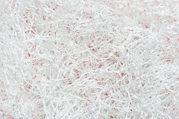 Texture of white paper filler. Background of shredded and cut paper. Filler for transporting fragile items. Flat lay. Top view.
