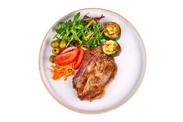 Grilled pork steaks with vegetable salad, isolated on white background.