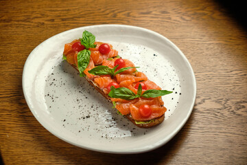 Bruschetta with pickled trout and salmon basil and tomatoes