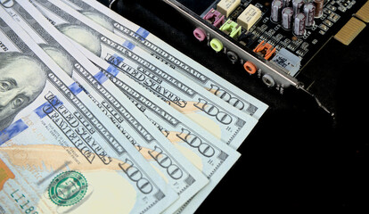 Electronic circuits, microchips, substrates for technology with dollars lying nearby. Electronics cost concept