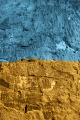 Yellow and blue Ukrainian flag on a peeling paint wall. Stop the war, help Ukraine. Copyspace
