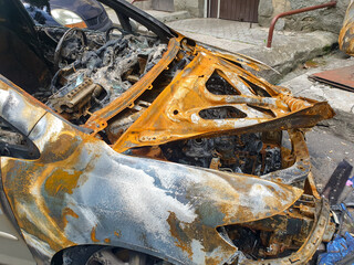 Closeup of burnt car on the city street arsoned by vandals