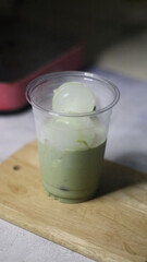 Iced matcha green tea on wood                        