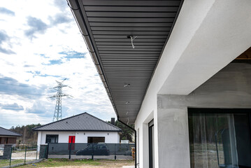 A modern graphite roof lining is attached to the trusses, visible cables and holes for LED lights.