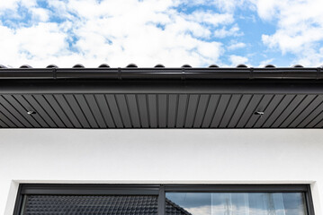 A modern graphite roof lining is attached to the trusses, visible cables and holes for LED lights.