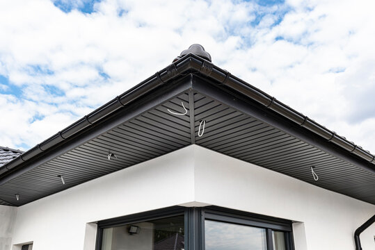 A modern graphite roof lining is attached to the trusses, visible cables and holes for LED lights.