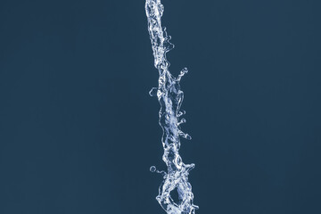 Water splash on a blue background. Reflection on the surface of the water.