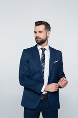 successful businessman in blue suit looking away isolated on grey.