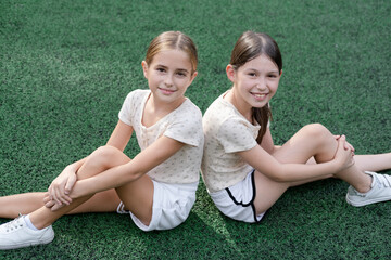 sisterhood. two sisters or friends spending time outdoors on sunny summer day. bff, sibling,...