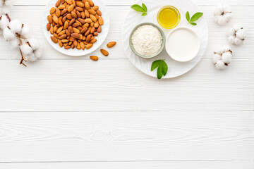 Sweet almond oil and milk with nuts seeds. Healthy food and cosmetic background
