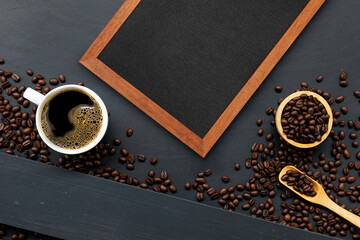 cup of coffee, wooden frame and bean on black wooden table background. top view. space for text. flay lay