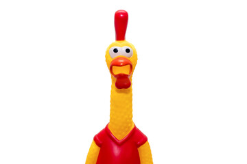 Rubber toy in the form of a rooster on a white background. The funny toy rooster has a surprised...
