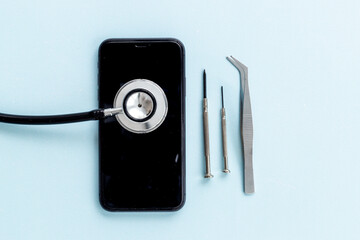 Electronics repair servise concept - mobile phone with stethoscope