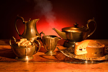 A vintage pewter tea set, with delicious cake served on a vintage cake plate.  