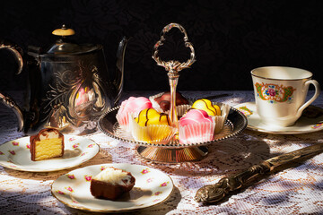 Vintage tea party, with french fancies.  The teapot, cake stand, plates and teacup are all vintage.