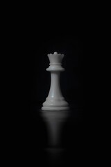 white chess piece in black background