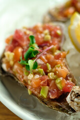 Beef tartar with salad and garlic toast on dark bread