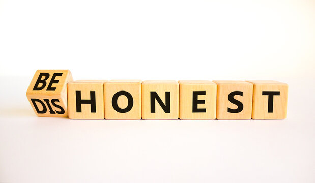 Be honest or dishonest symbol. Turned cube and changed concept words Dishonest to Be honest. Beautiful white table white background. Business and be honest or dishonest concept. Copy space.