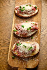Beef tartar with salad and garlic toast on dark bread