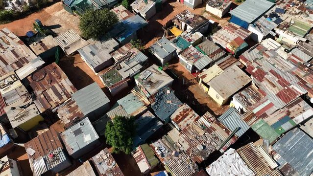 Poverty. Aerial zoom out view of densely over crowded shacks in an informal settlement township slum