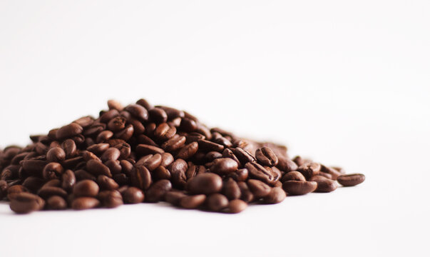 A heap of coffee beans on white