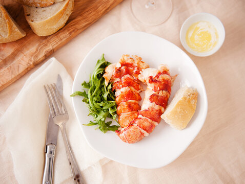 Lobster tails with bread, butter and greens