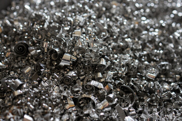A lot of metal shavings close-up, after working on a milling machine or CNC machine. - obrazy, fototapety, plakaty