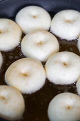 A round Japanese homemade doughnut or Bomboloni, sweet bakery prepared for fried with hot oil.
