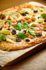 Pizza with bacon and ham and tomatoes