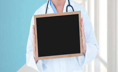 Doctor holding a blank blackboard