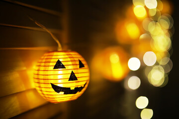 The concept of light on the night Halloween.Round lamp shape of pumpkin used to decorate with bokeh and copy space for text.