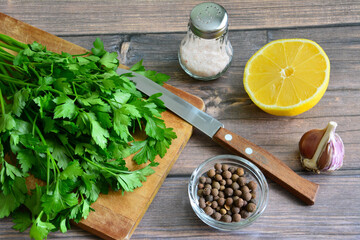 green fresh bunch of parsley on cutting board with kitchen knife