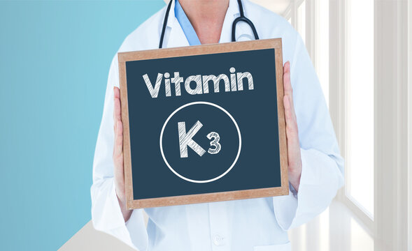 Vitamin K3 - Doctor shows information on blackboard.Doctor holding chalkboard with text.