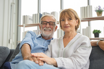 A simple day of a retired couple. Mature couple sitting in the living room