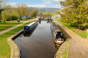 Narrowboats moored up on a tranquil leafy part of the Llangollen canal in the Trevor Basin at the Froncysyllte aqueduct on the inland waterway network in North Wales UK