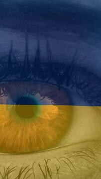 Animation of flag of ukraine waving over open eye of caucasisan woman
