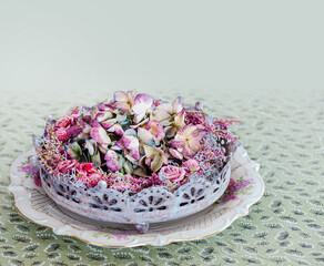 pink and purple dried flowers. Hortensia, rose flowers and herbs arrangement isolated on light green tablecloth background. home decoration interior