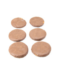 broken chocolate coating biscuits over on white background, selective focus, top view