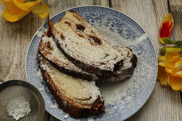 Delicious and tasty backed cake  decorated with Yellow freesias. slices cake in a plate 