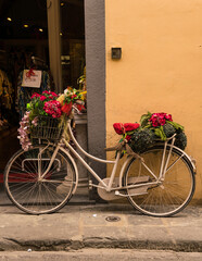 old bicycle with front basket and flowers