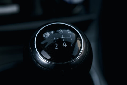 Close-up of the car's manual transmission gearshift. Low key