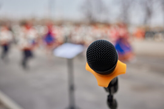 Microphone on blurred background with copy space for text or lettering, toned.
