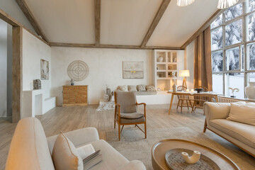 cozy warm home interior of a chic country chalet with a huge panoramic window overlooking the winter forest. open plan, wood decoration, warm colors and a family hearth