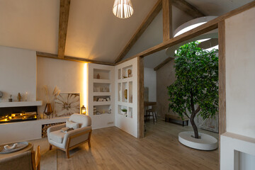 cozy warm home interior of a chic country house with an open plan, wood finishes, warm colors and a family hearth. view of the recreation area for family and guests