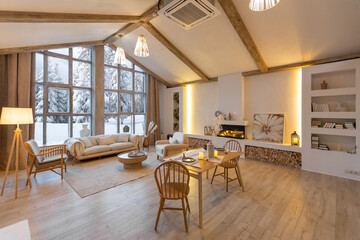 cozy warm home interior of a chic country chalet with a huge panoramic window overlooking the...
